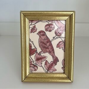 burgundy bird motif paper in an antiqued gold frame
